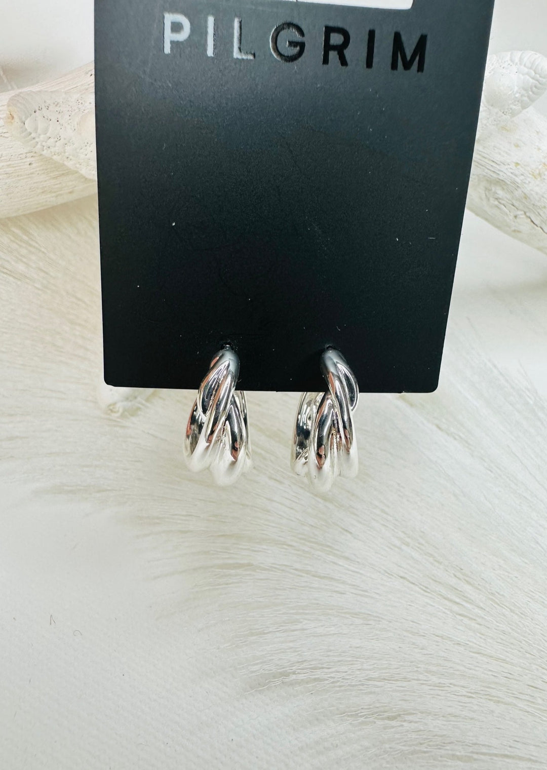COURAGEOUS TWIRL HUGGIE HOOP EARRINGS